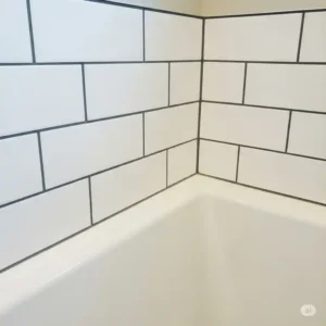 Close-up view of subway tile installation around a bathtub, showcasing grout lines.