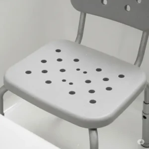 Durable, non-slip material and efficient drainage holes on a bathtub chair for seniors, promoting hygiene and preventing water buildup.