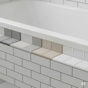 Detail shot showing different grout color options for subway tiles around a bathtub.