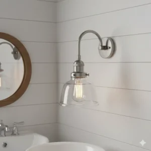 Transitional bathroom vanity light with a brushed nickel frame and clear glass shades.