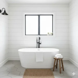 A classic white clawfoot tub paired with contemporary black fixtures, central to the white modern farmhouse bathroom aesthetic.