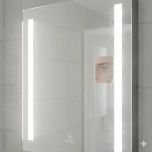 Detail shot of the integrated defogger pad on a premium lighted medicine cabinet mirror, essential for post-shower use. 