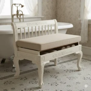 Vintage cushioned bench for bathroom near a clawfoot tub, featuring ornate legs.
