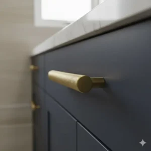 Extreme close-up of a brushed brass handle with knurled texture for grip, a trendy option for heavy-duty bathroom unit handles.